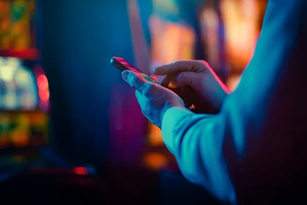 A woman in a luxurious green gown next to an ornate roulette wheel, capturing the upscale casino mood of 67777.
